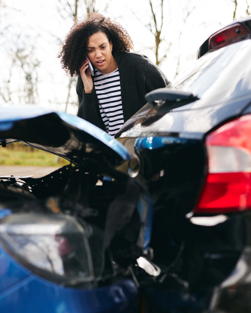 Food delivery car accident in Central Florida with a driver standing near damaged vehicles